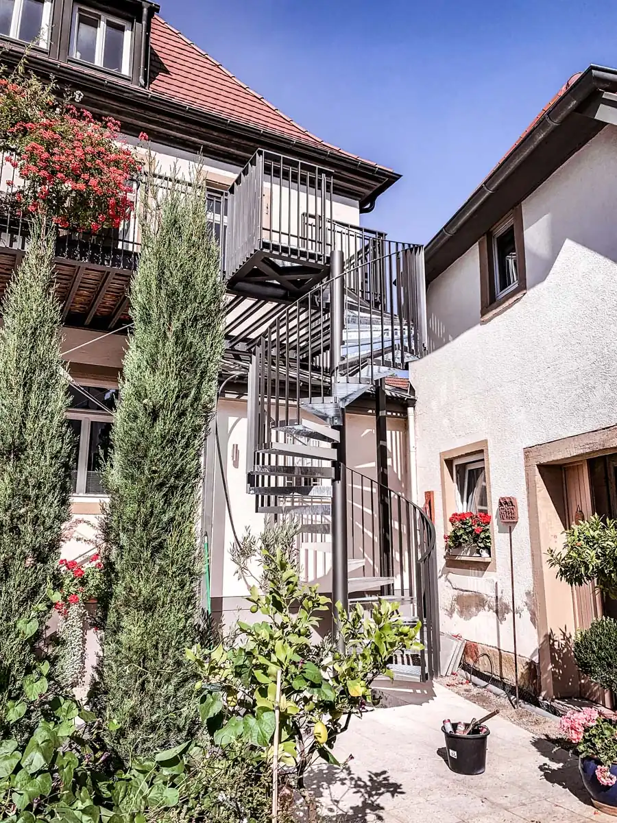 Stahl-Spindeltreppe außen an einem Altbau im Innenhof